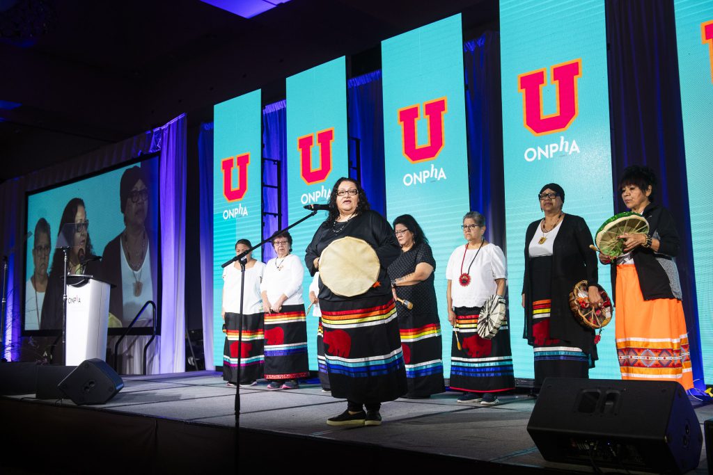 Indigenous women performing on stage