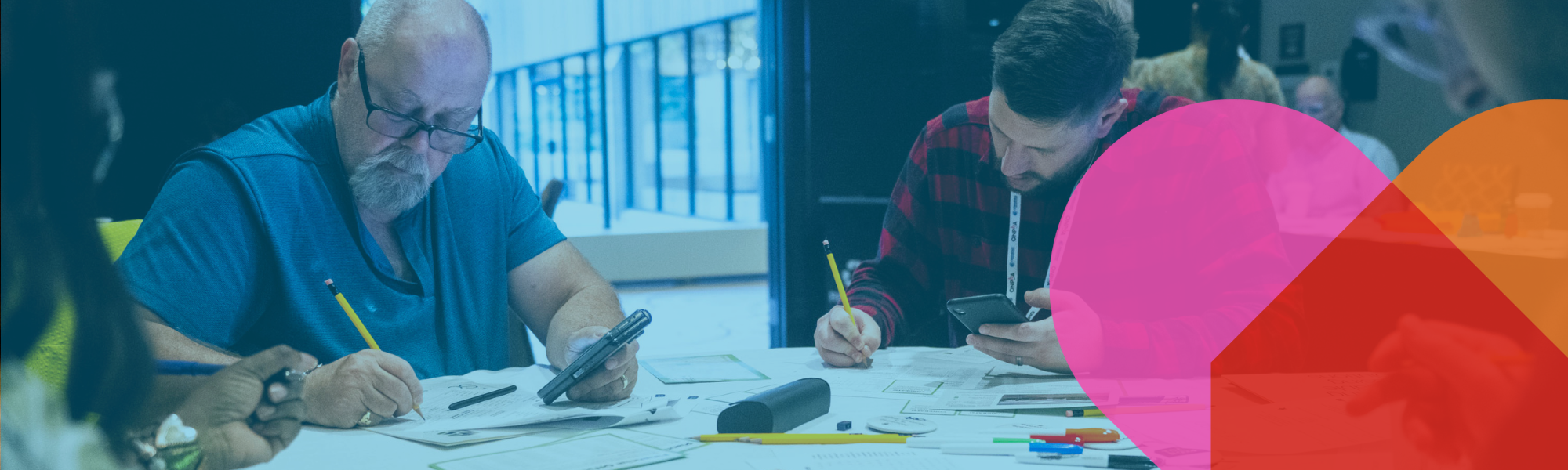 Two delegates making calculations at an ONPHA U workshop