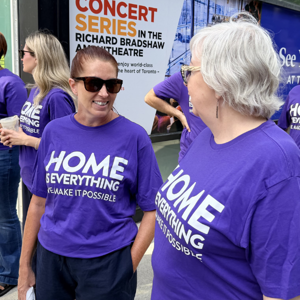 ONPHA Staff wearing the 2026 ONPHA Conference t-shirt that says "Home is everything, we make it possible"